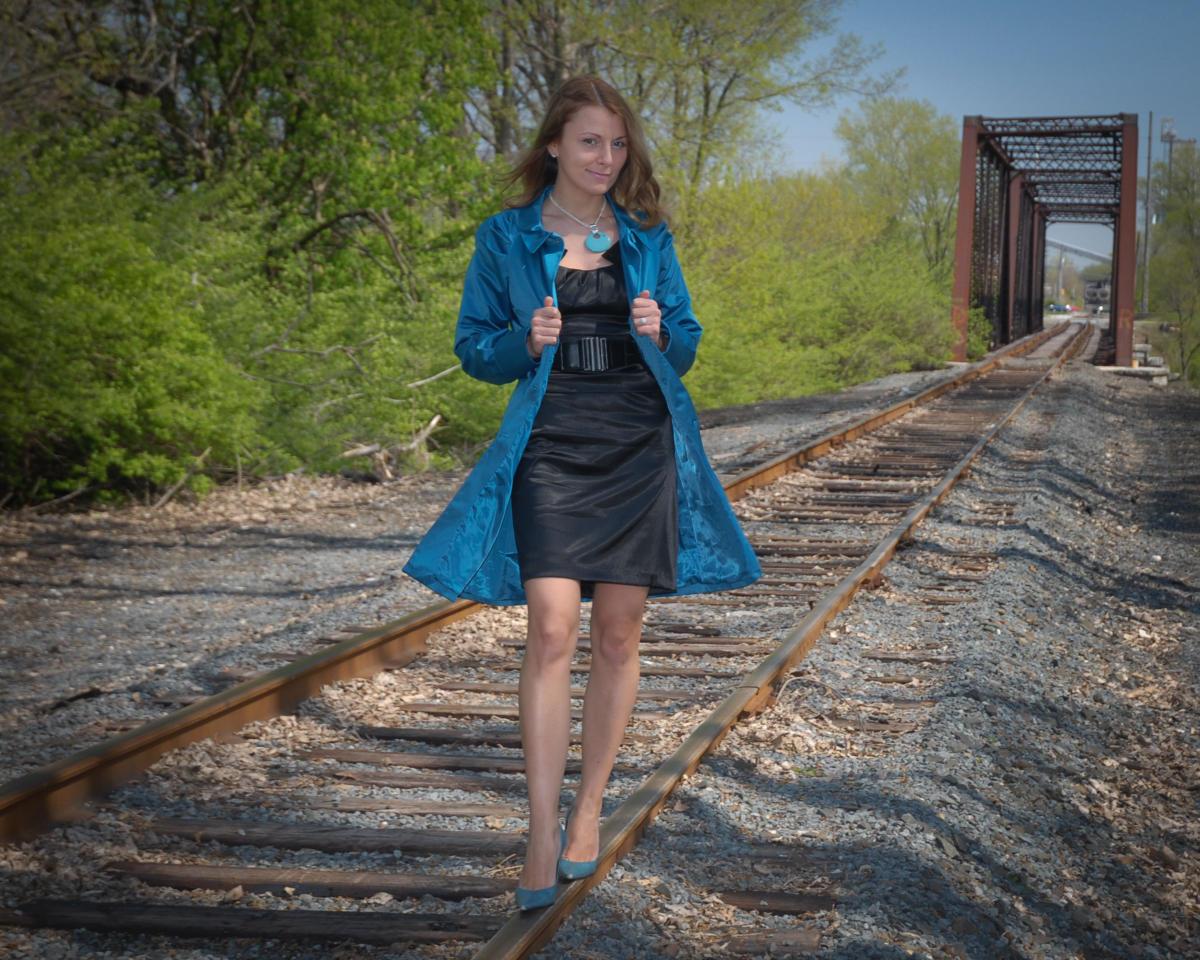 Female blue coat railroad tracks