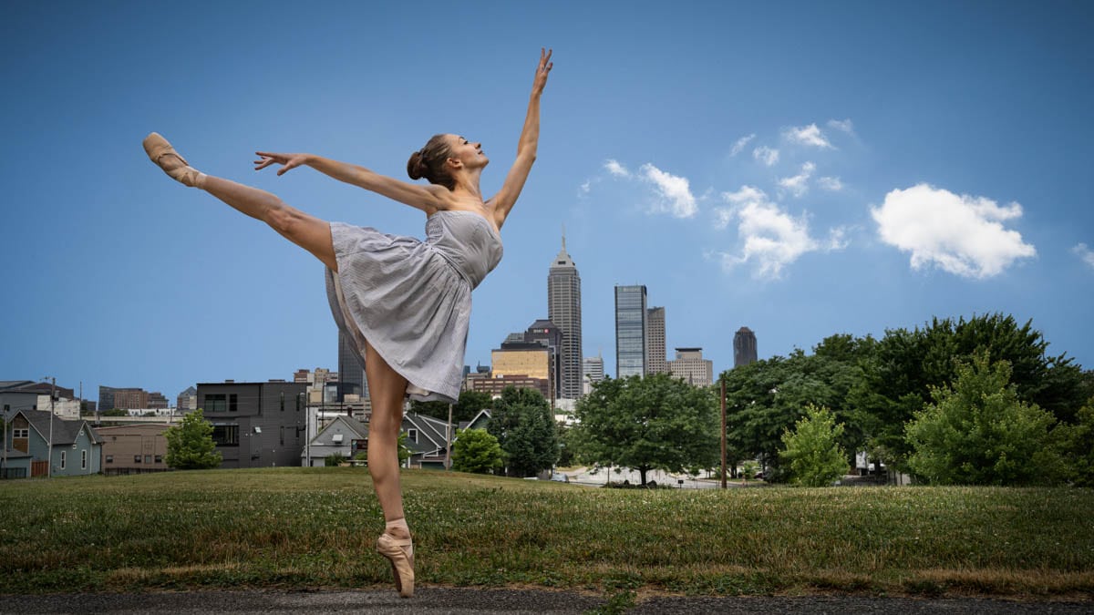 ballerina arabesque against a skyline