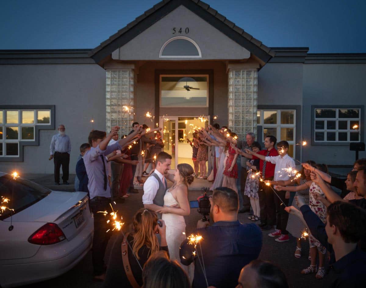 couple leaving reception with sparklers