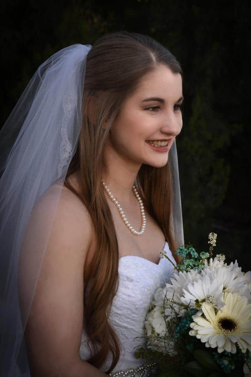 smiling bride in veil with pearls