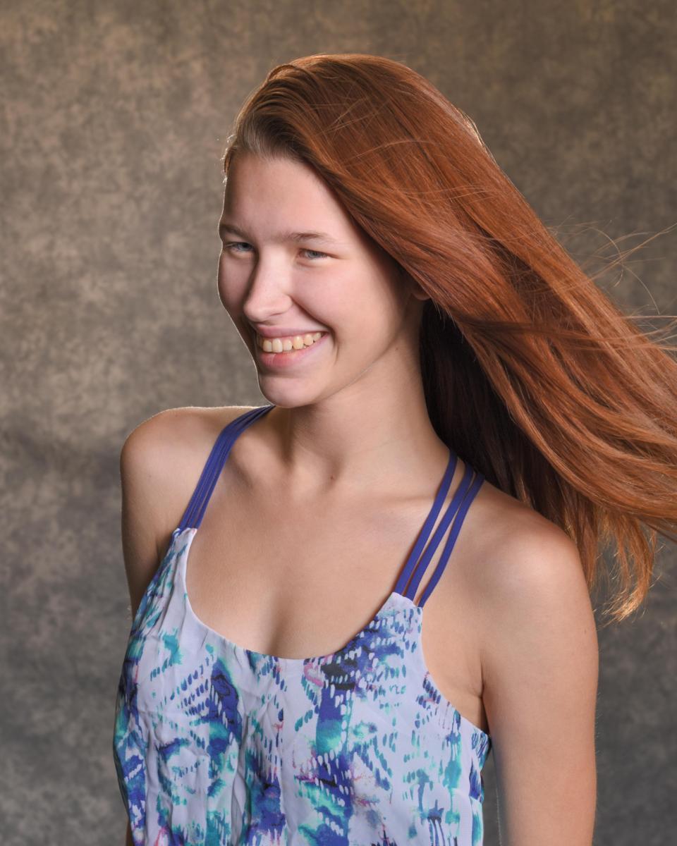 smiling summer redhead studio portrait