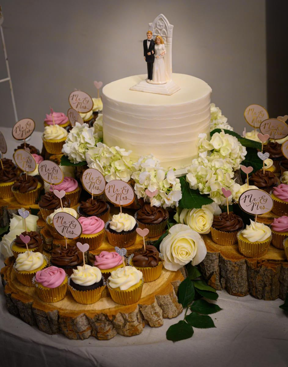 wedding cake display with cupcakes