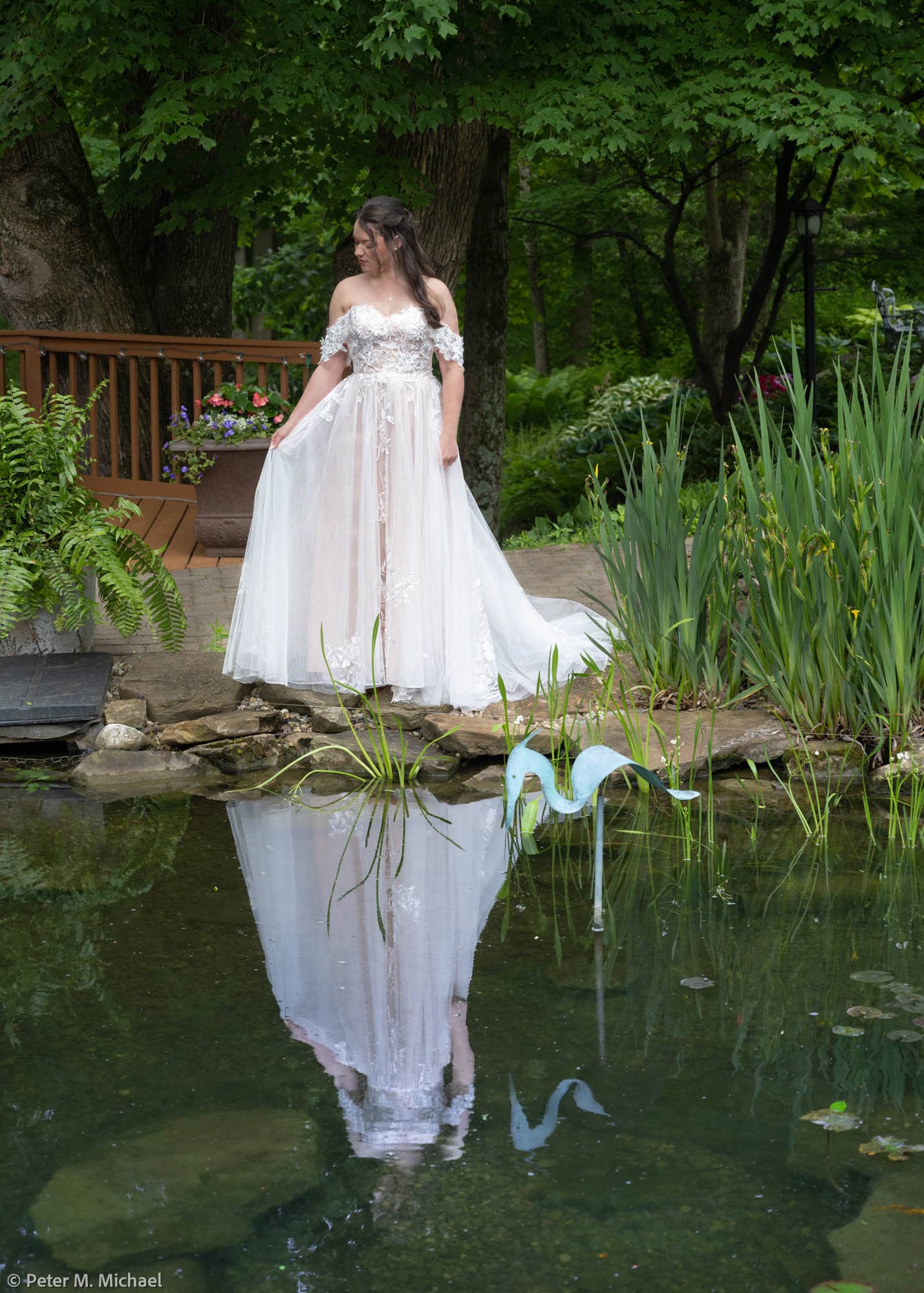 bride admiring dress reflection outdoors