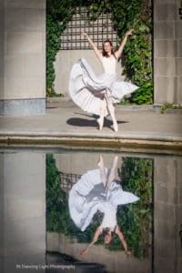 Ballet dancer with her reflection in the In the still water of the Indianapolis canal