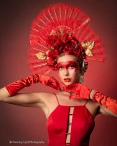 Portrait of a fashion model with a red headdress and red gloves