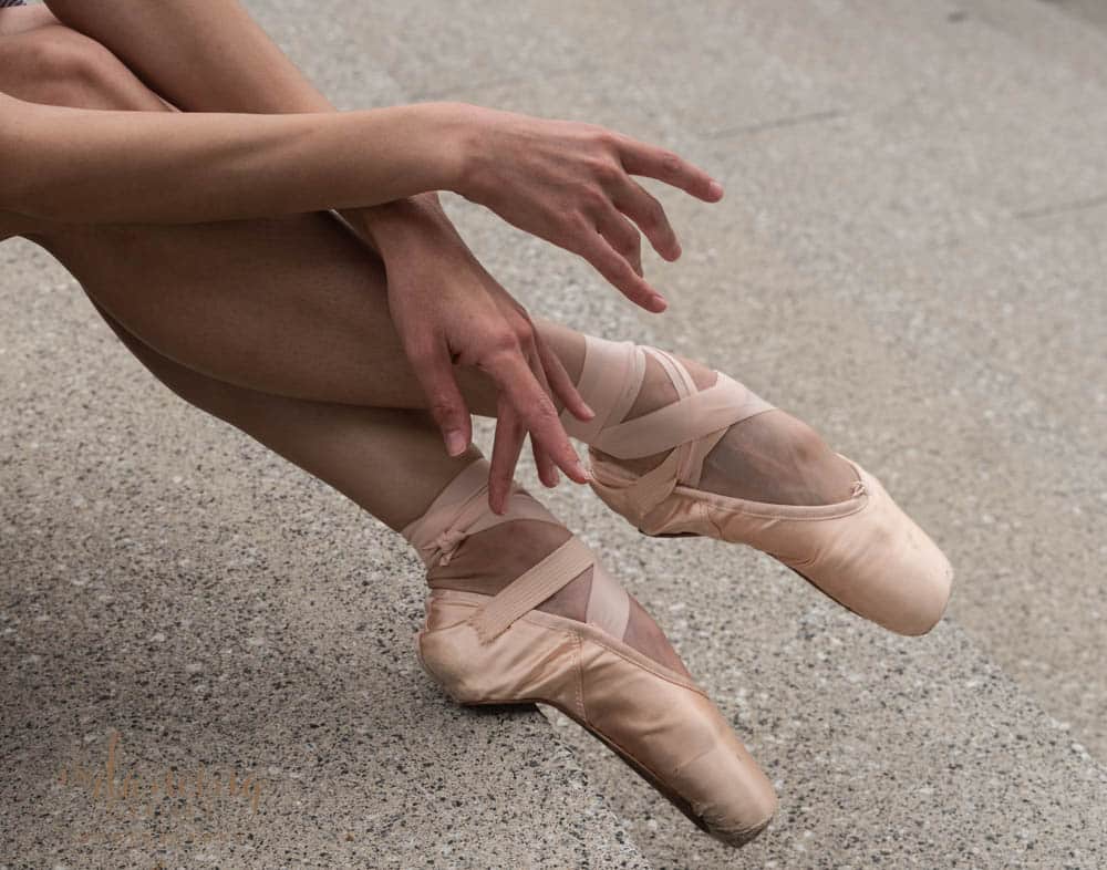 Ballet dancer's hands and pointe shoes