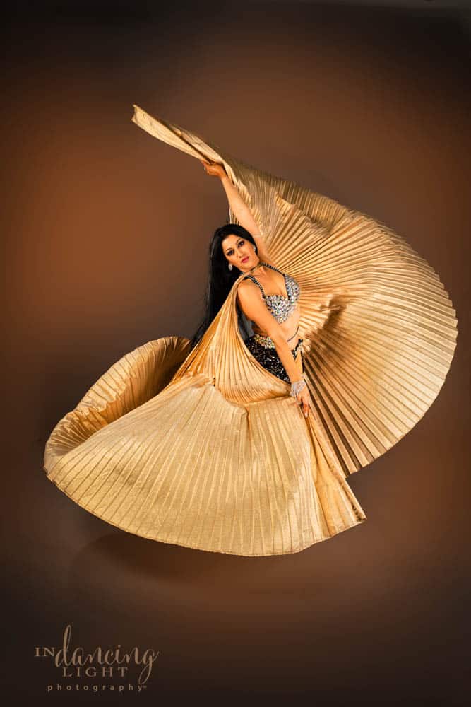 Mediterranean dancer twirls as she spreads out golden wings