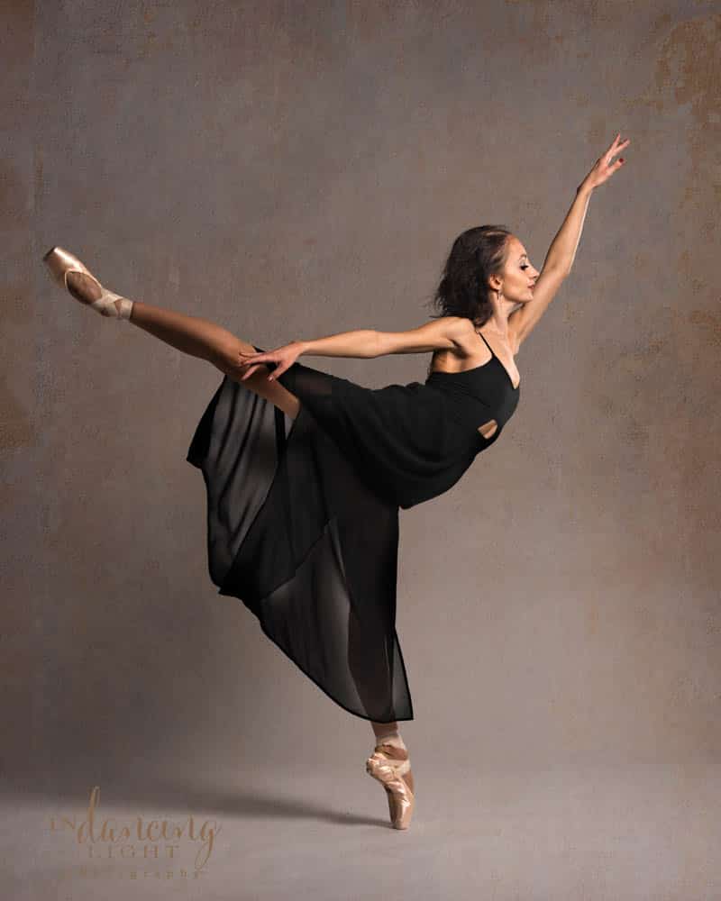 Ballet dancer in a black dress on pointe