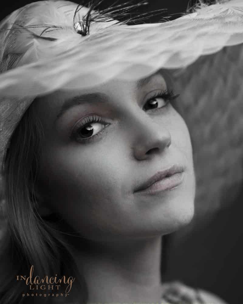 Monochrome glamor portrait of a woman wearing a hat