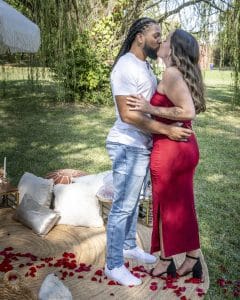 Embracing for a kiss after she said "I will". 